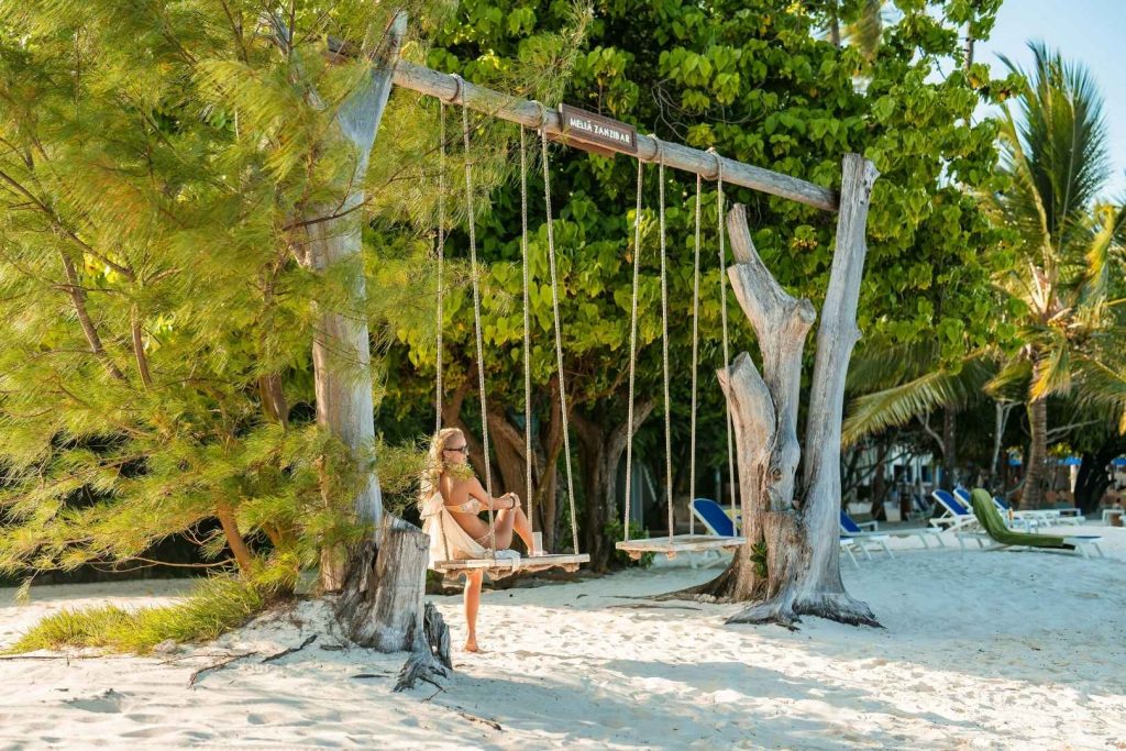 A tourist enjoying Zanzibar Beach while on Safari